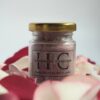 100gm handmade bath salt in glass jar with gold lid surrounded by rose petals